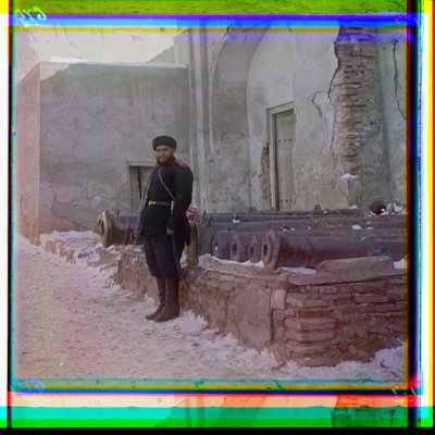 A Russian Soldier Stands Guard at a Palace Next to Old Cannons in Bukhara, 1915 by Sergey Prokudin Gorsky